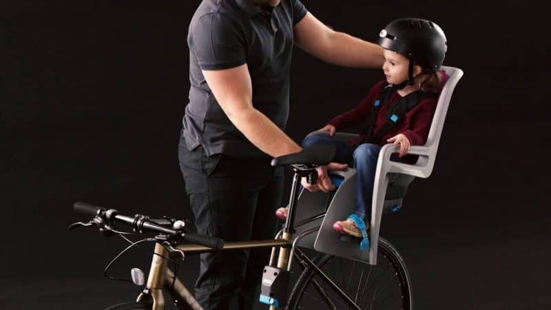 Child riding in THULE child bike seat RIDEALONG