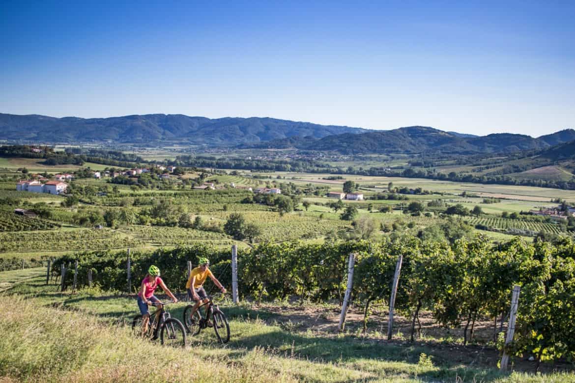 Couple riding E-bikes in the Vipava valley Slovenia. Photo by Anita Ferjancic, RockVelo