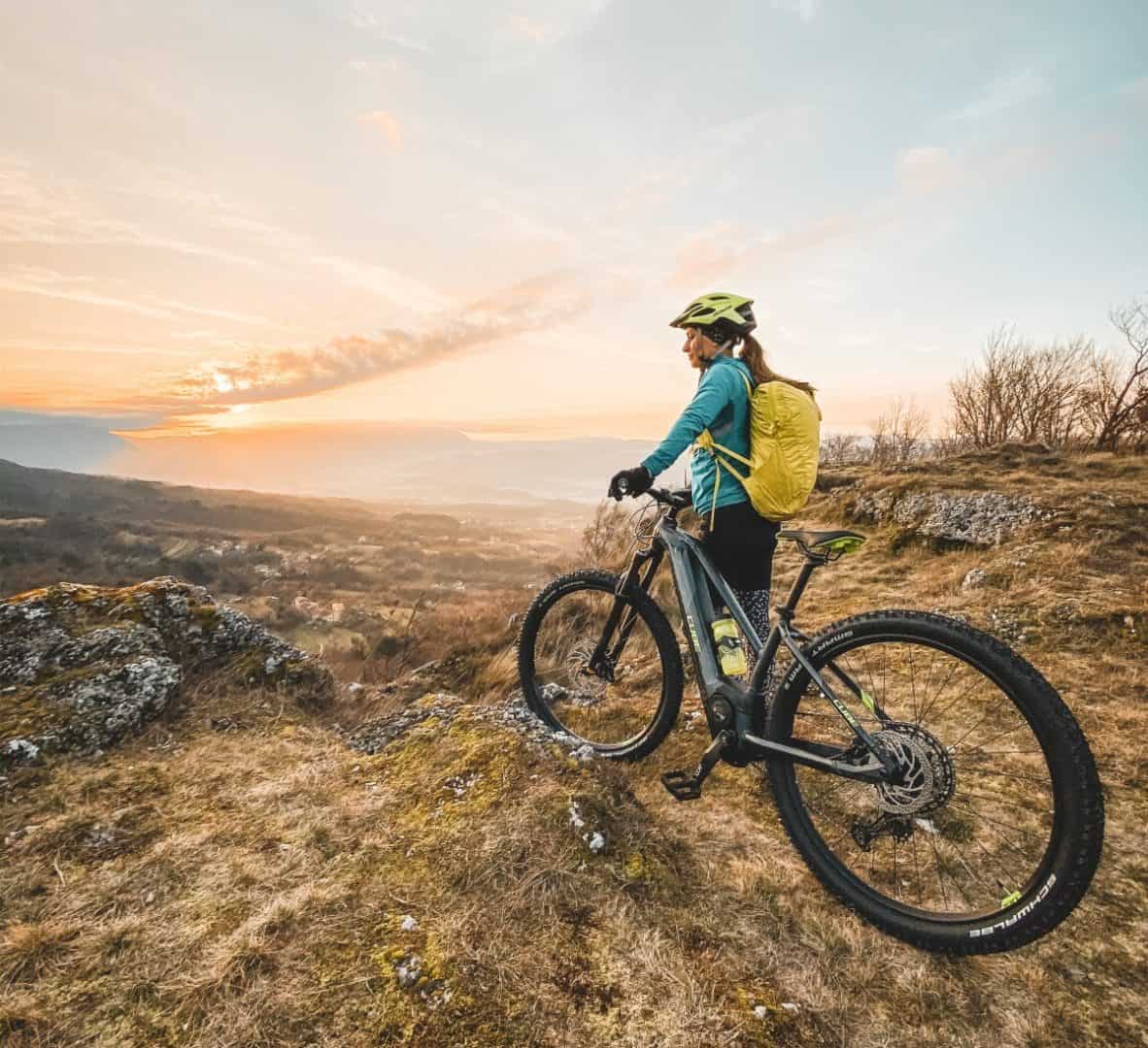 Woman with rental e-bike above Vipava valley. RockVelo Tours