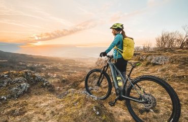 Woman with rental e-bike above Vipava valley. RockVelo Tours