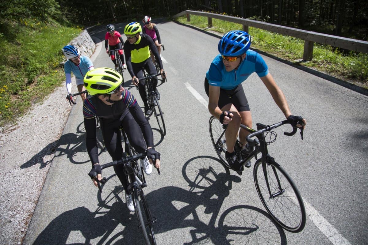 Group of road cyclist riding vrsic pass in Slovenia. Road tour by RockVelo